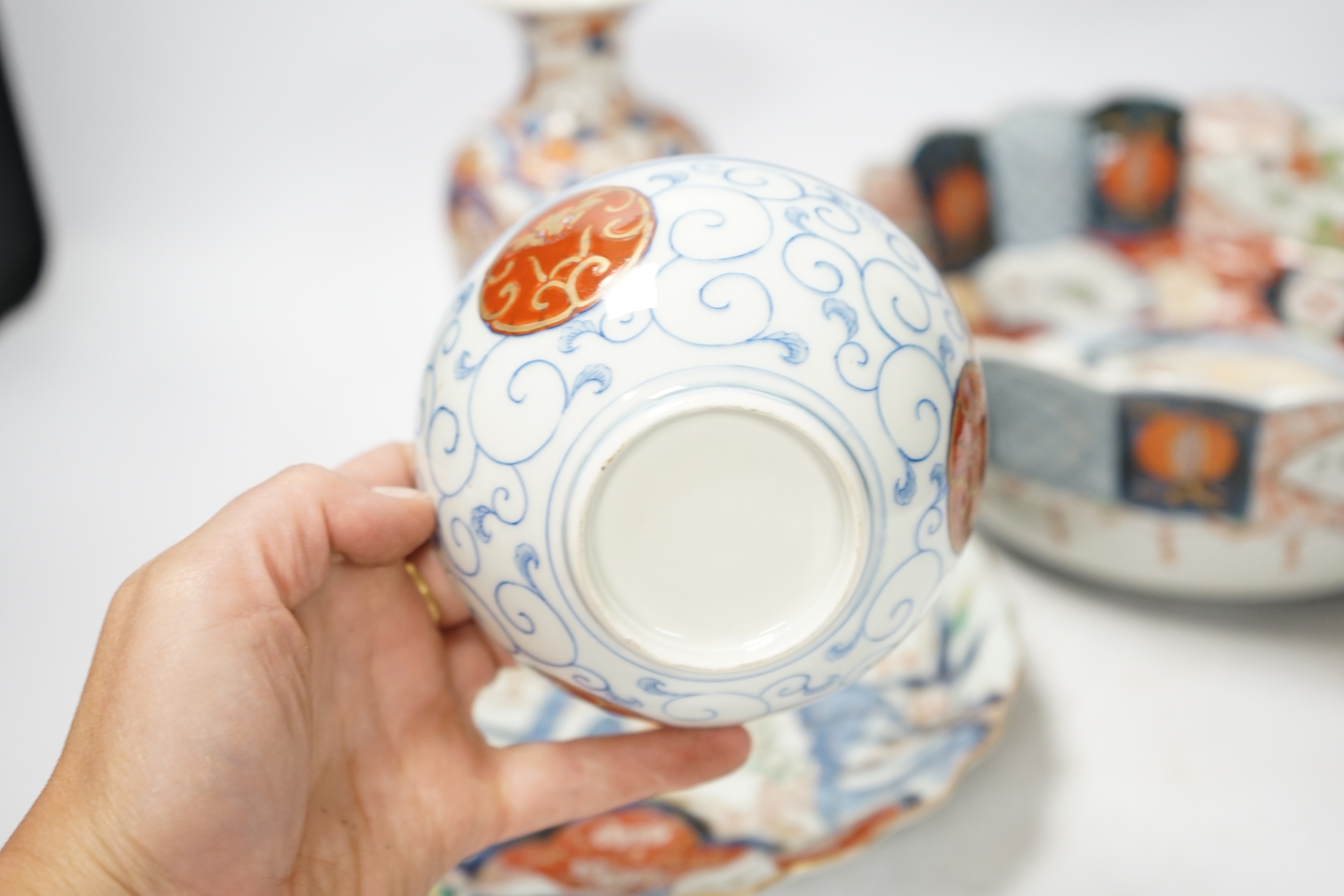 Japanese ceramics to include an Imari vase and bowl and a blue and white dish, 22cm diameter. Condition - two bowls and dish good, others poor